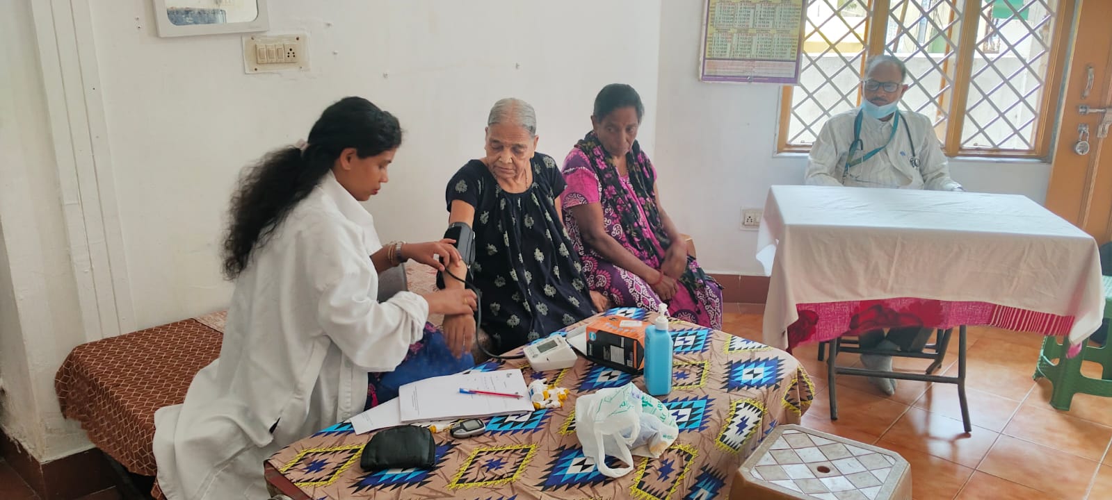 Doctor conducting blood pressure check on elderly resident
